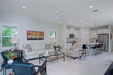Living area with a ceiling fan, recessed lighting,
