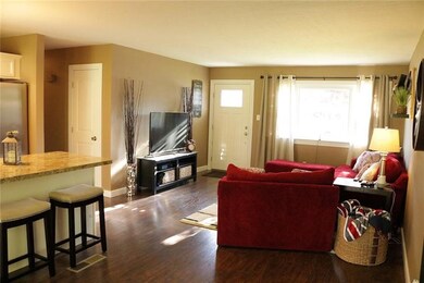 Standing in dining area looking into living room and kitchen area and island.