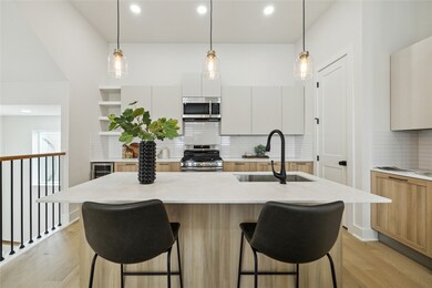 Modern kitchen featuring sleek cabinetry, stainles