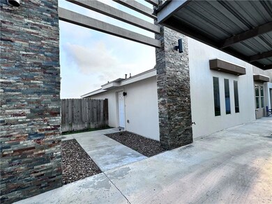 View of side of home with stucco siding, fence, a patio, and stone siding