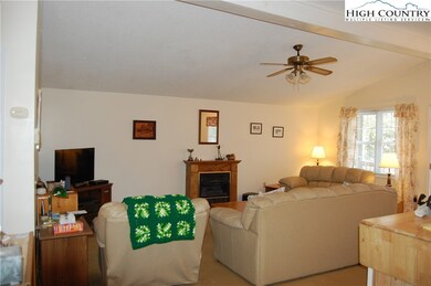 Open den, kitchen, and dining.  Gas log heater for