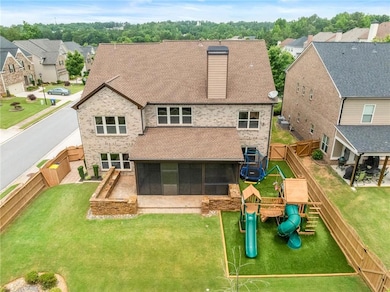 Back of house featuring a playground, a sunroom, a residential view, and a shingled roof
