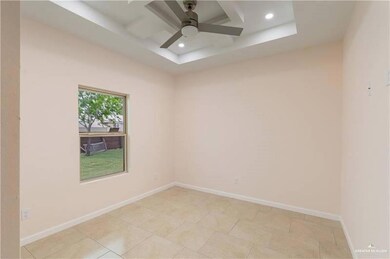 Empty room featuring ceiling fan, recessed lighting, and a tray ceiling