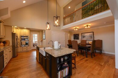 Combination Kitchen and Dining with vaulted ceilings and loft
