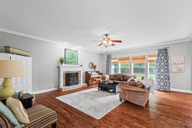 What a great place to entertain - wood burning fireplace, tons of natural light, crown molding and opens to kitchen/breakfast area.