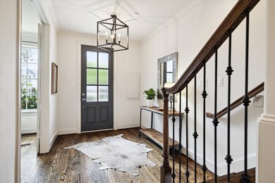 Bright and stylish entryway with glass-paneled fro