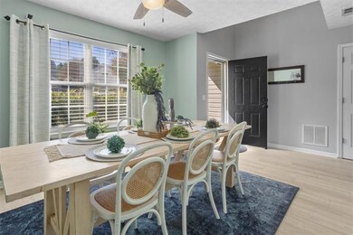 Dining space featuring light wood finished floors, a textured ceiling, and ceiling fan