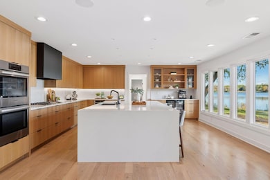 A stunning waterfall island anchors this sleek kitchen with form and function.
