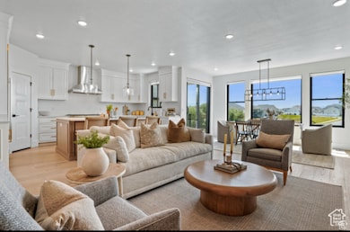 Living room with a chandelier and light wood-type flooring