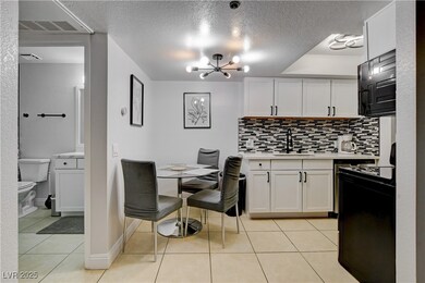 Kitchen featuring a sink, stove, light countertops