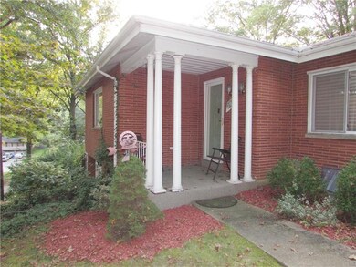 The Covered Front Porch, with stately Pillars, lea