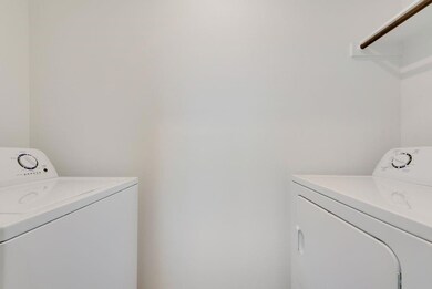 Washroom featuring laundry area and washing machin