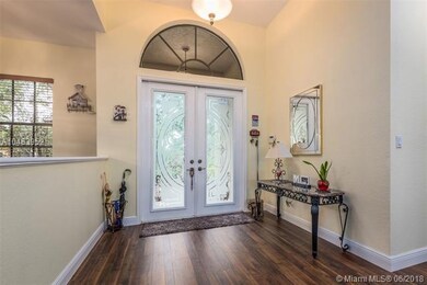 Spacious formal foyer entry with custom etched gla