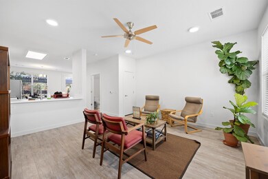 Sitting room featuring light wood-type flooring, recessed lighting, a ceiling fan, and an office area