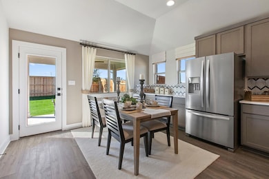 Dining space with dark wood-type flooring and recessed lighting
