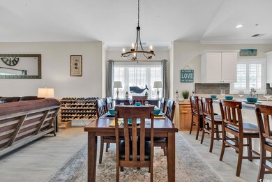 Dining area featuring visible vents, a chandelier,