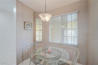 Dining area with light tile patterned flooring and baseboards