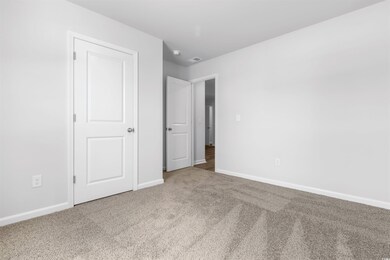 Unfurnished bedroom with carpet