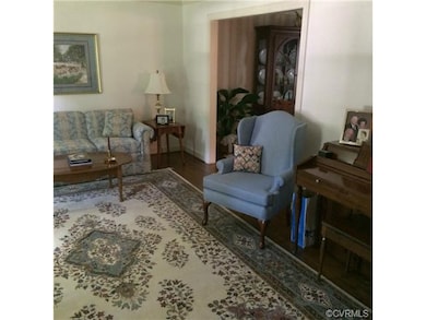 Formal living room with wood floor and crown mould