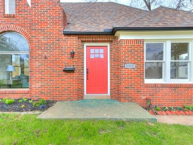 Entrance to property with a lawn