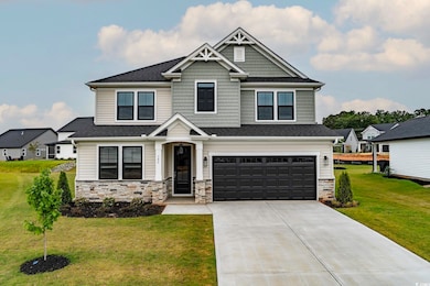 Craftsman house featuring stone siding, an attached garage, concrete driveway, roof with shingles, and a front lawn