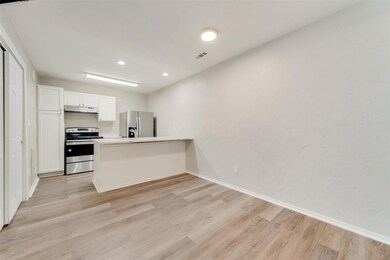 Kitchen featuring kitchen peninsula, appliances wi