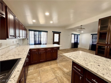 Kitchen featuring lofted ceiling with beams, light