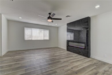 Unfurnished living room featuring wood finished fl