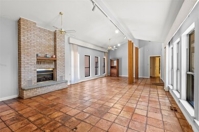Unfurnished living room with a brick fireplace, ra
