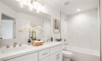 Full bathroom with shower / bath combination, double vanity, and recessed lighting