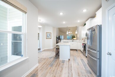 Kitchen featuring white cabinets, stainless steel 