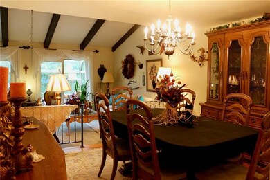 Brass light fixture in the Dining Room sits 8 comf