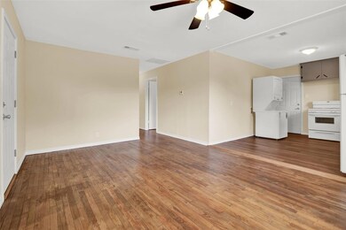 Living room with ceiling fan and hardwood / wood-s