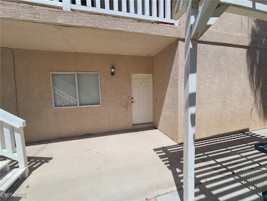Doorway to property with stucco siding and a patio