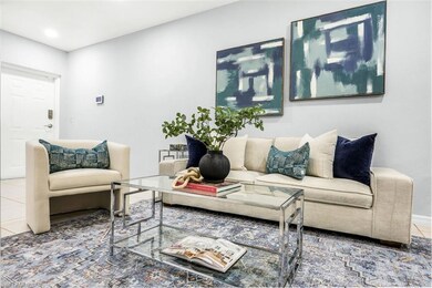 Living area with baseboards, tile patterned floori