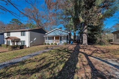 View of front of home with a front yard and covered porch