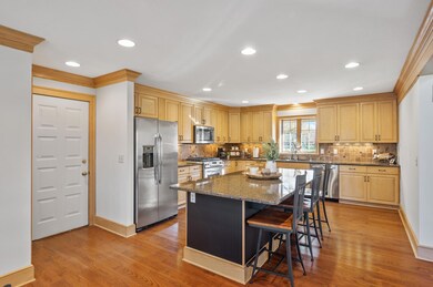 The open floor plan seamlessly connects to the kitchen, boasting abundant storage and a spacious center island with seating.