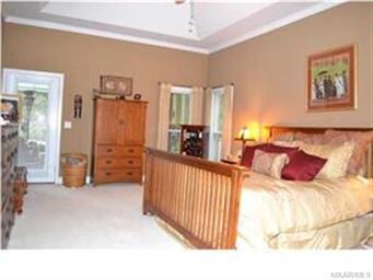 The luxurious downstairs master bedroom has a tray ceiling and access to the screened porch.