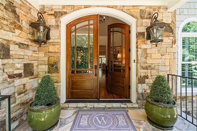 Entrance to property with stone siding