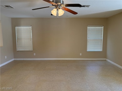 Unfurnished room with baseboards and ceiling fan