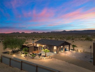 View of front of home with a mountain view, a dese
