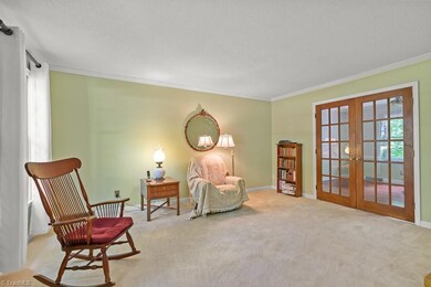 Large formal living room with doors leading to dining room.