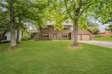 View of front of property featuring concrete driveway and brick siding