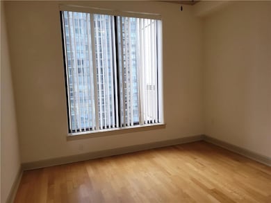 Empty room featuring wood finished floors and baseboards