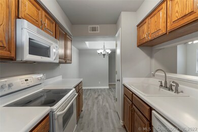 Galley Kitchen that is Bright & Cheery opens to th