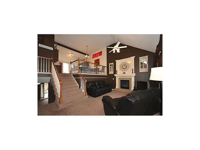 SPACIOUS LIVING ROOM FEATURES FIREPLACE.