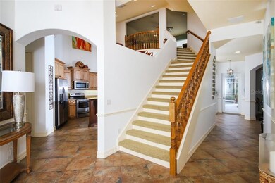 Entry with stairway to the loft and kitchen beyond