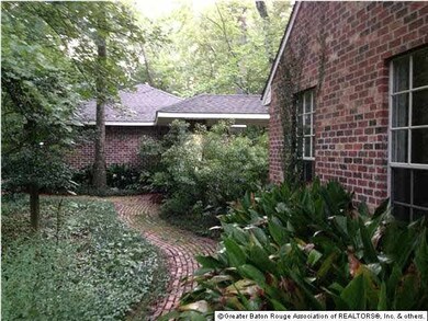 Brick walkway along side of house