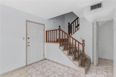 Entrance foyer with stairway and baseboards