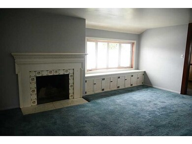Living Room. Fireplace, hardwood beneath the carpe